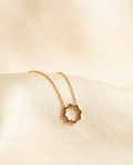 Shamsa Pendant — gold eight-pointed Shamsa pendant on fine chain, cream silk