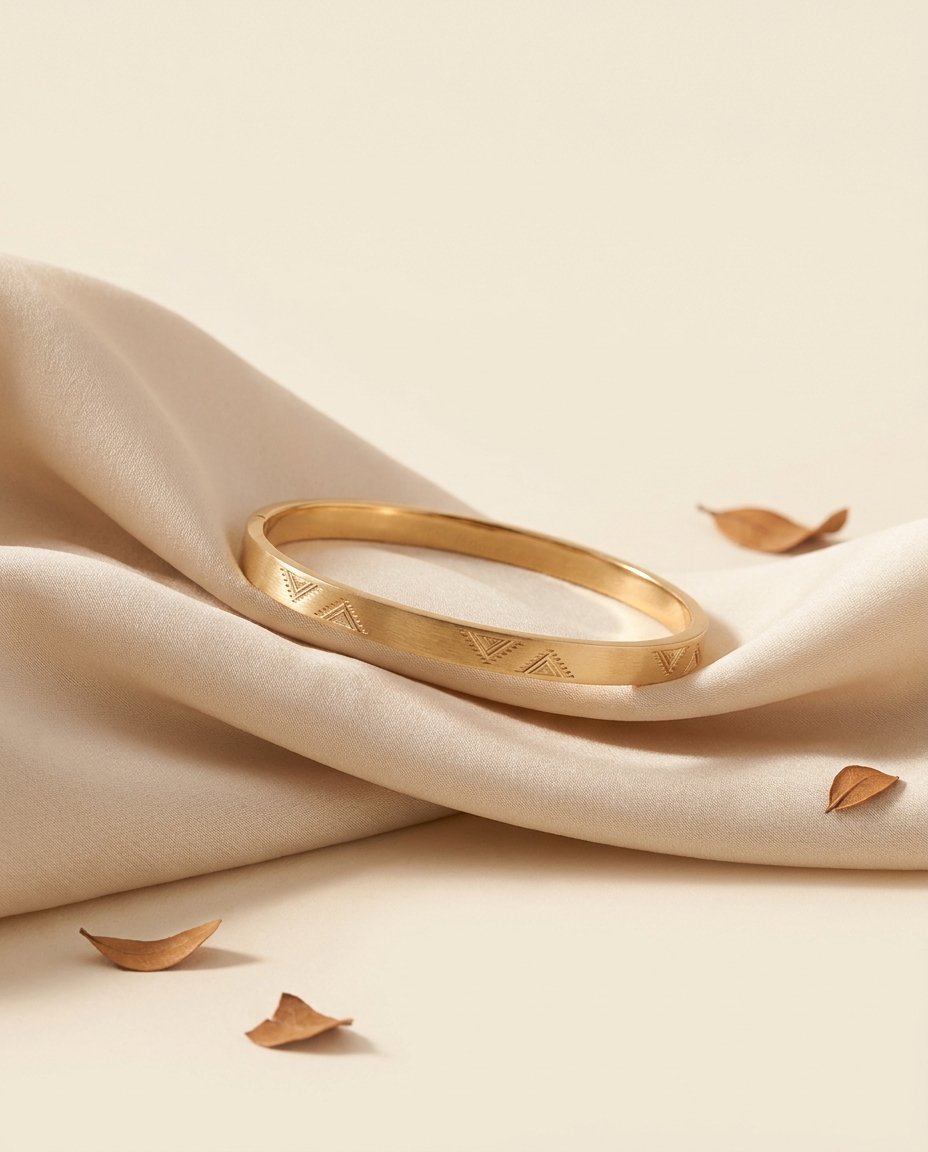 Sadu Bangle — slim 18k gold bangle with Sadu weaving pattern, on cream silk